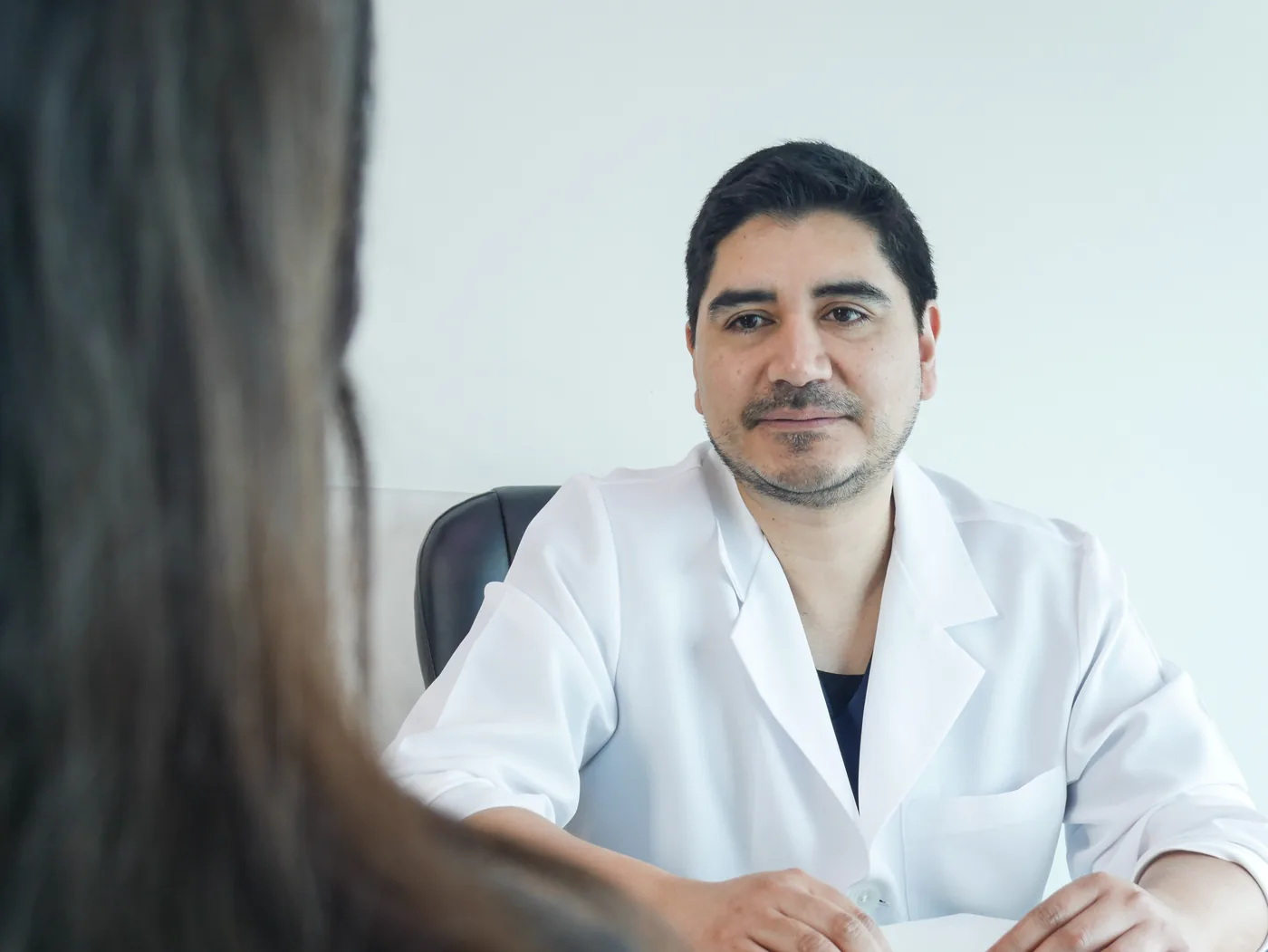 Dr. Luis Schwarz escuchando atentamente la historia clínica y síntomas del paciente